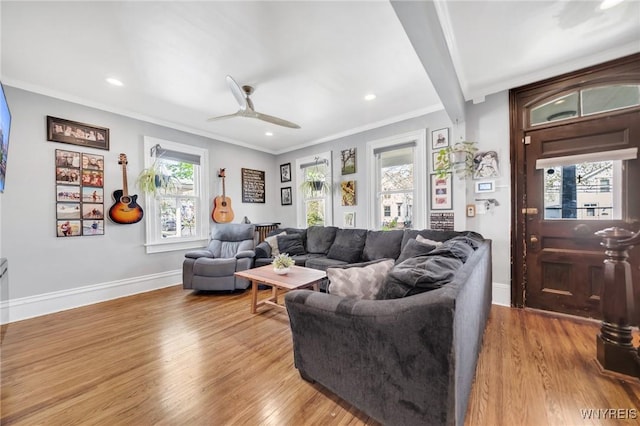 living room featuring wood finished floors, ornamental molding, ceiling fan, recessed lighting, and baseboards