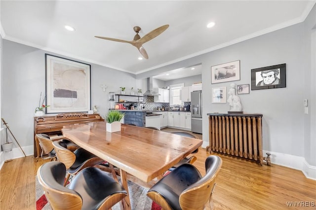dining area with light wood-style flooring, ceiling fan, recessed lighting, ornamental molding, and baseboards