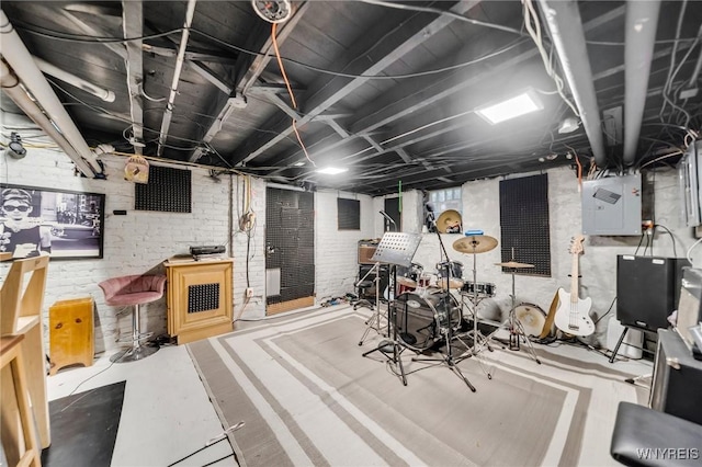 basement with electric panel and brick wall