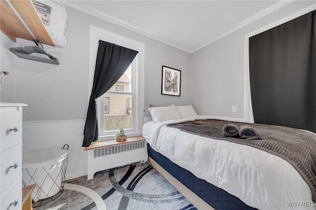 bedroom featuring radiator heating unit, ornamental molding, carpet, and baseboards