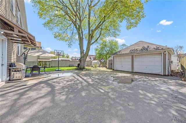 detached garage featuring fence