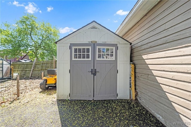 view of shed featuring fence