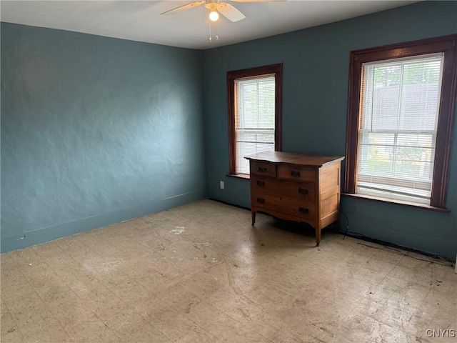 1270 W Belden Ave, Syracuse, NY 13204 - empty room featuring healthy amount of natural light, a ceiling fan, and tile patterned floors