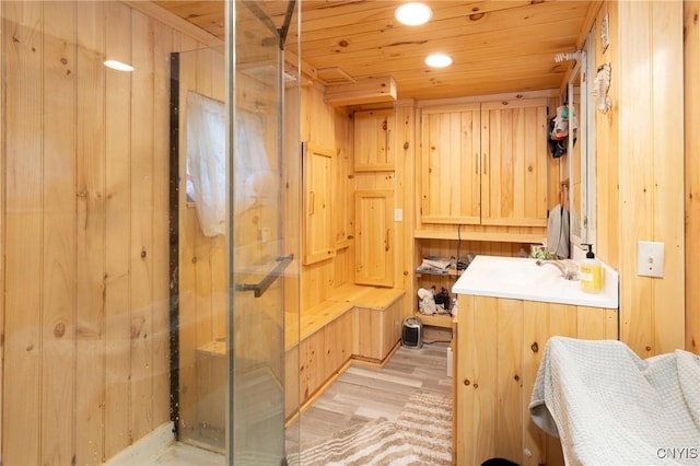 bathroom with a shower stall, wood finished floors, wooden ceiling, recessed lighting, and vanity