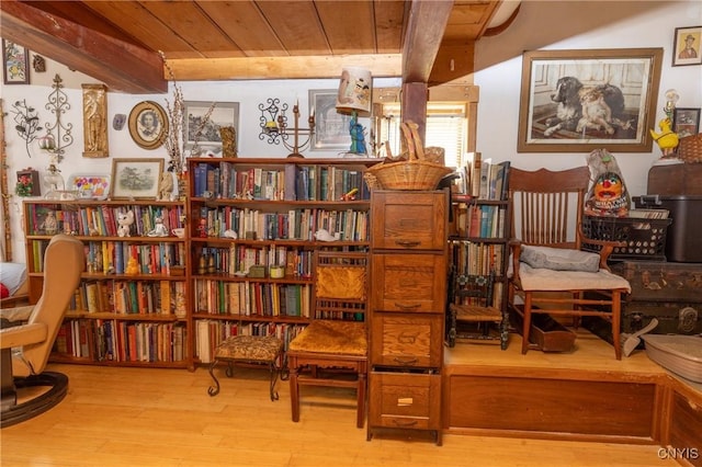 sitting room with wood ceiling, wood finished floors, and beamed ceiling