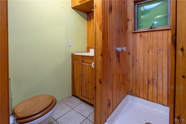 bathroom featuring toilet, tile patterned flooring, and vanity