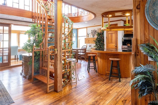 bar with hardwood / wood-style floors and plenty of natural light