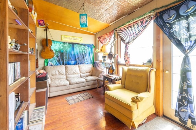 living area featuring an ornate ceiling and wood finished floors