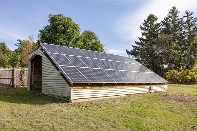 view of outbuilding featuring solar panels