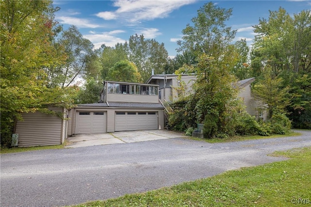 view of front of home with concrete driveway and an attached garage