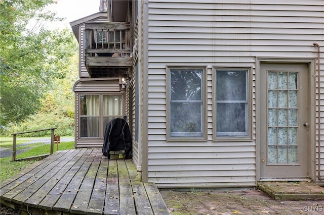 view of side of home with a wooden deck