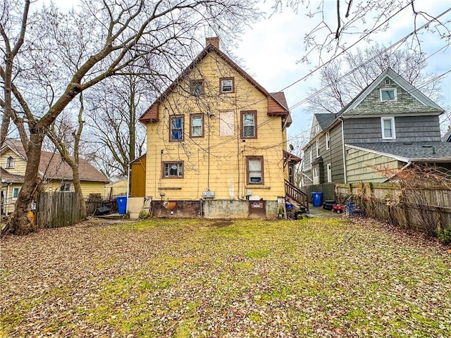 13 Brooklyn St, Rochester, NY 14613 - rear view of house with a chimney and fence