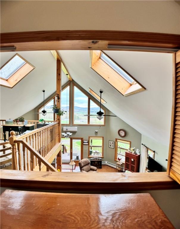 575 Harper Rd, Harpersfield, NY 13786 - living area with a skylight, high vaulted ceiling, and a baseboard heating unit