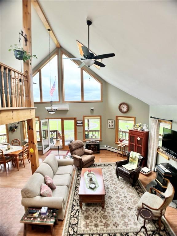 575 Harper Rd, Harpersfield, NY 13786 - living room featuring high vaulted ceiling, a ceiling fan, a baseboard radiator, and wood finished floors