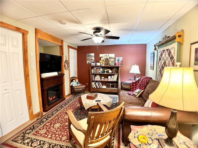 575 Harper Rd, Harpersfield, NY 13786 - living room with a paneled ceiling, ceiling fan, and a glass covered fireplace