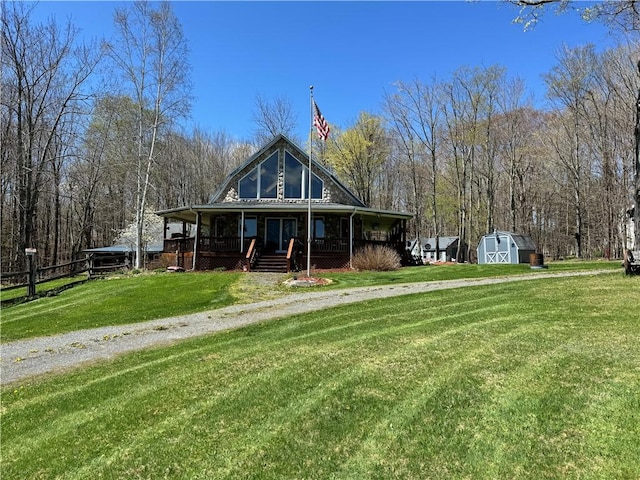 575 Harper Rd, Harpersfield, NY 13786 - view of front of house with a shed, a porch, an outbuilding, and a front lawn