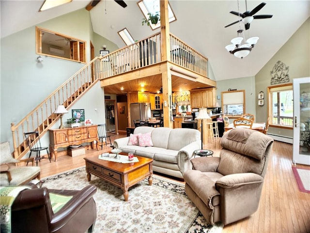 575 Harper Rd, Harpersfield, NY 13786 - living room with ceiling fan, high vaulted ceiling, baseboard heating, hardwood / wood-style flooring, and stairs