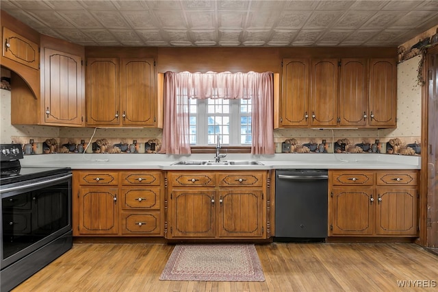 kitchen featuring black range with electric cooktop, dishwasher, a sink, an ornate ceiling, and brown cabinetry
