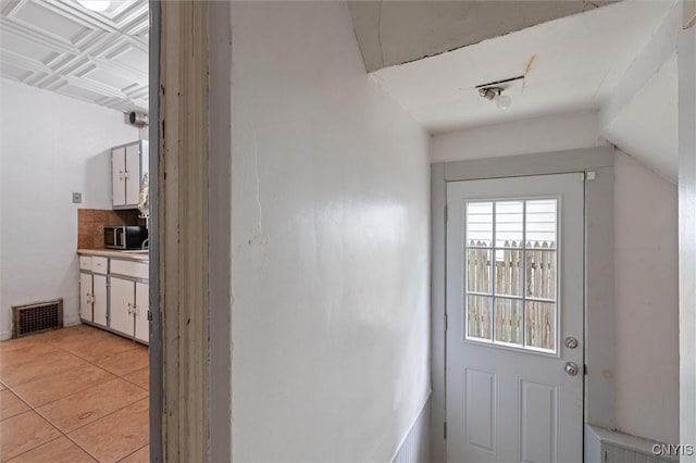 entryway featuring light tile patterned flooring