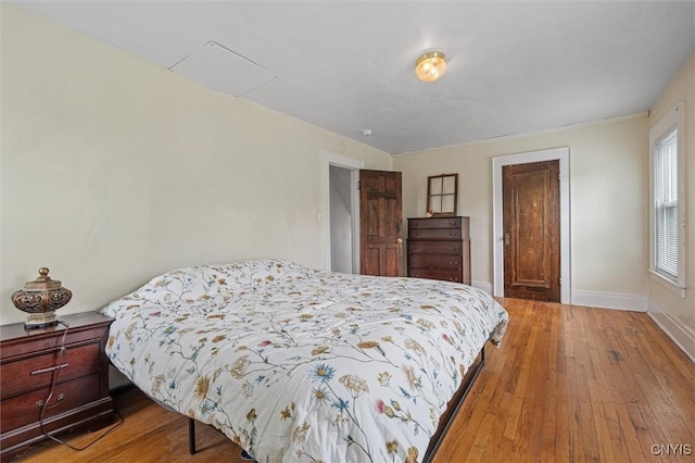 bedroom featuring wood-type flooring and baseboards