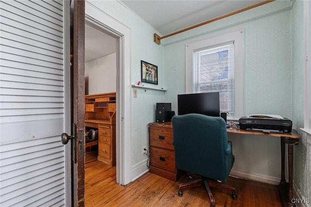 home office featuring crown molding and wood finished floors