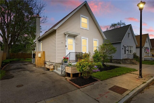 bungalow-style house with fence