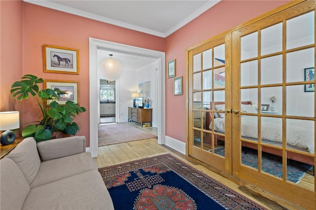 doorway to outside with french doors, baseboards, wood finished floors, and ornamental molding