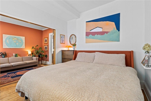 bedroom with wood finished floors and baseboards