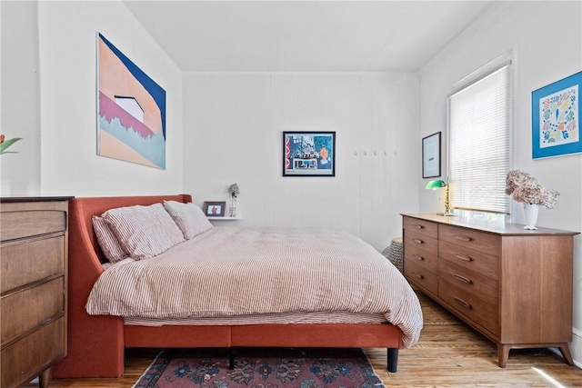 bedroom with light wood finished floors