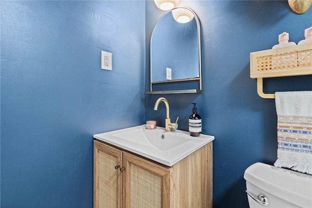 half bathroom featuring vanity and toilet