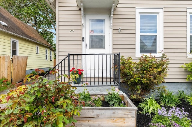 view of exterior entry featuring fence