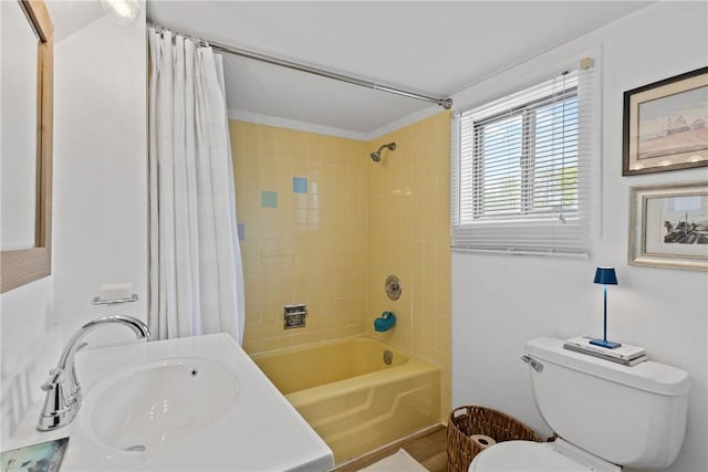 full bath with toilet, a sink, and shower / bath combination with curtain