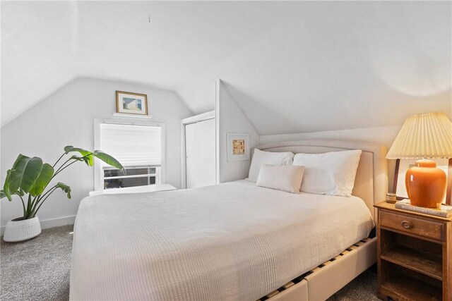 carpeted bedroom with lofted ceiling, baseboards, and cooling unit