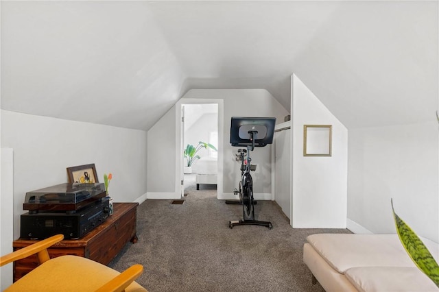 exercise room featuring carpet flooring, lofted ceiling, and baseboards