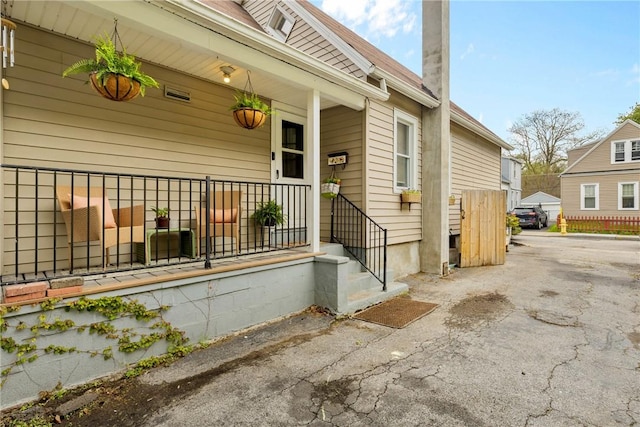view of exterior entry with covered porch