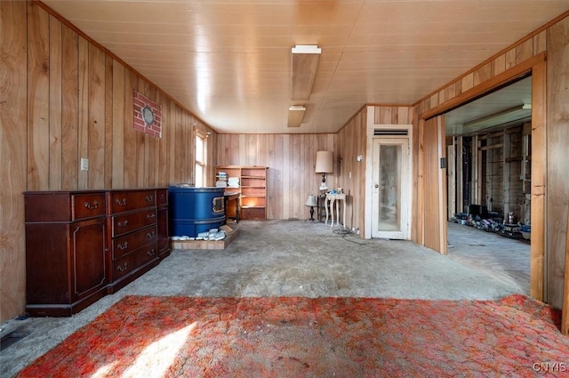7709 State Highway 28, Exeter, NY 13439 - miscellaneous room featuring carpet flooring, a wood stove, and wooden walls