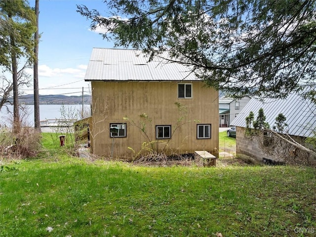 7709 State Highway 28, Exeter, NY 13439 - view of home's exterior with a water view, metal roof, and a lawn