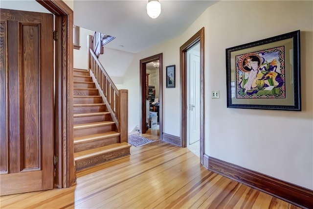 entrance foyer with light wood-type flooring and stairs