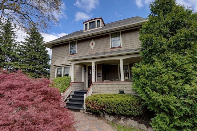american foursquare style home with covered porch