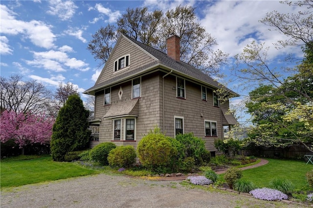 view of property exterior featuring a chimney and a shingled roof