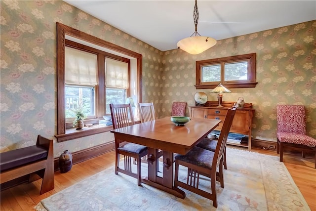 dining area featuring healthy amount of natural light and light wood-style floors