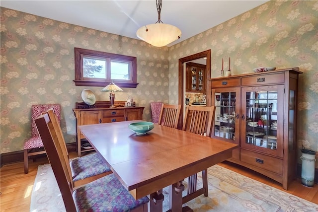 dining room with light wood-style flooring and french doors