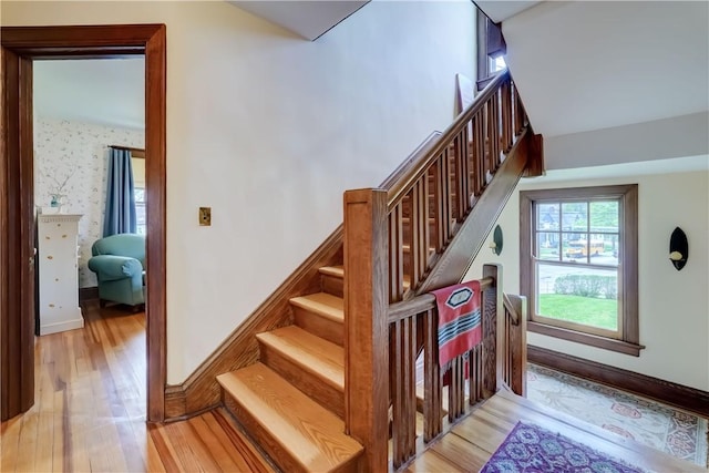 stairway featuring wood finished floors and baseboards