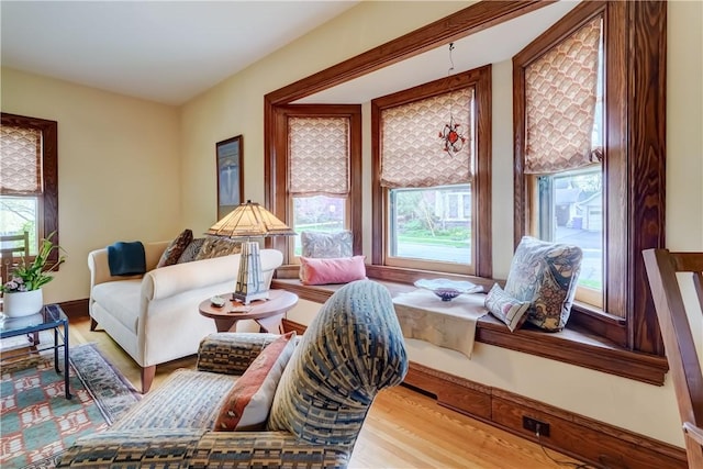 living room with plenty of natural light and wood finished floors
