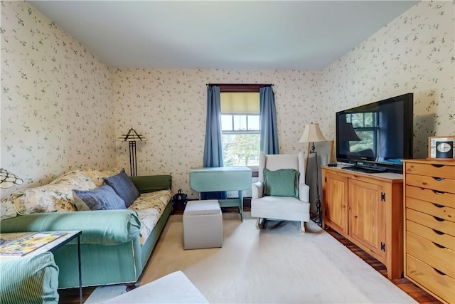 carpeted living room with wallpapered walls