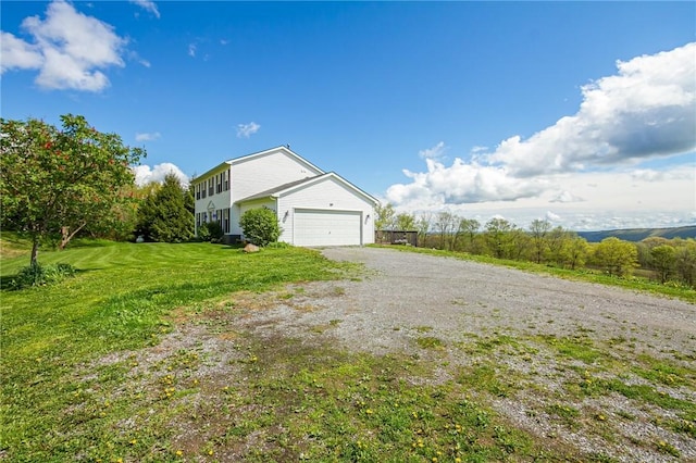 view of home's exterior featuring a lawn, driveway, and an attached garage