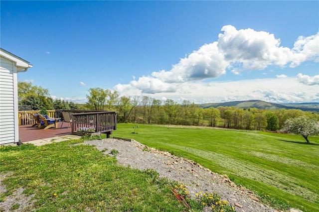 view of grassy yard featuring a deck