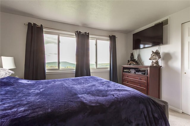 carpeted bedroom with baseboards