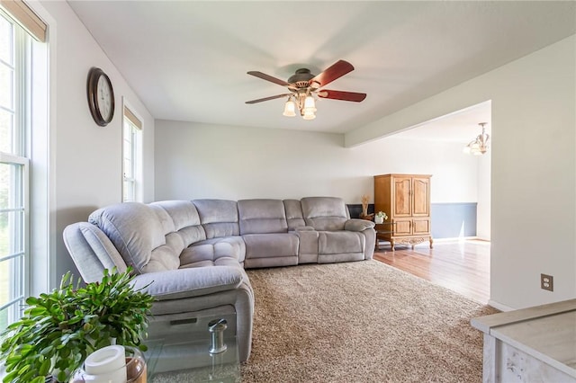 living room with ceiling fan and wood finished floors