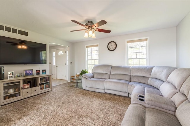 living room featuring a ceiling fan and carpet flooring